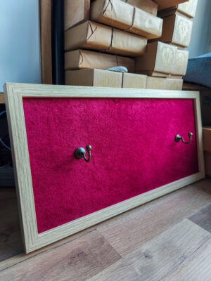 Jasna ramka z czerwoną dzianiną – ekspozytor na różdżkę