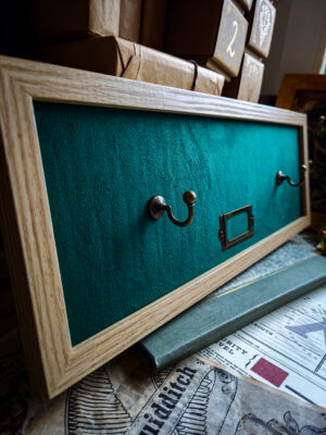 Jasna ramka z zielonym welurem – ekspozytor na różdżkę